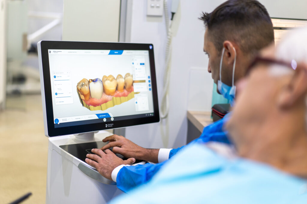 Dentist using 3D scanner to assess tooth condition