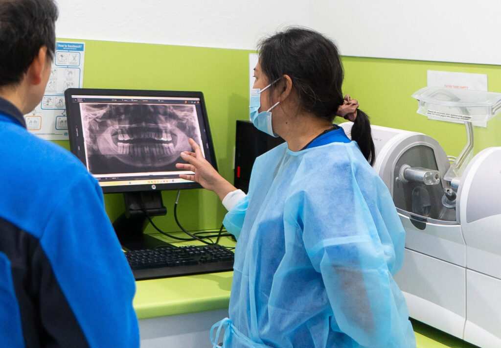 Dentist is explaining a dental scan to the patient