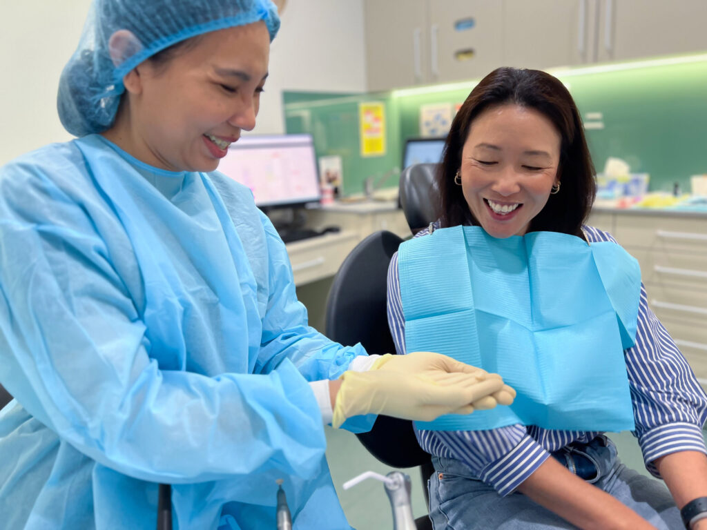 Dentist shows the new dental crown to a patient