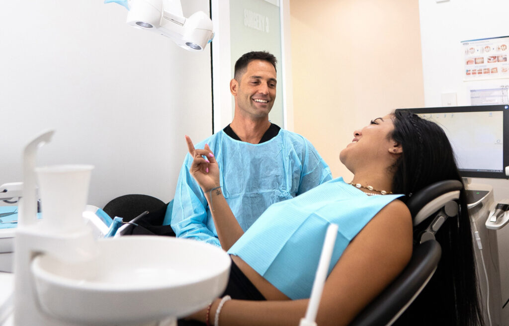 DSC00316_cropped | No Gaps Dental Dr. Thiago speaks with a patient in a dental chair