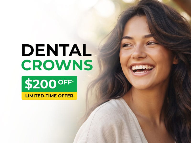 Smiling woman beside a dental crowns promotion offering $200 off for a limited time.